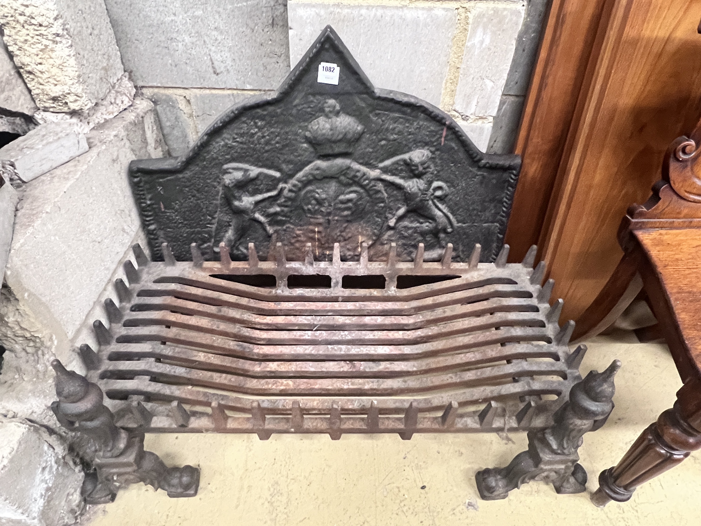 A cast and wrought iron fire grate, width 92cm, depth 42cm, with cast iron heraldic fire back, dogs and basket